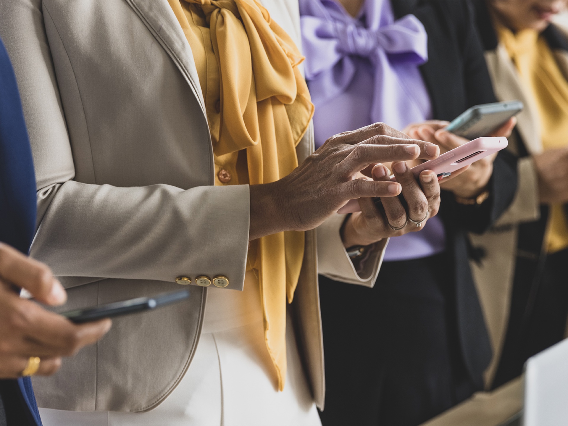 People using phones at a conference